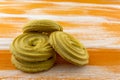 Round shortbread cookies lying on a wooden orange table