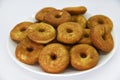 Round shortbread cookies on a plate. Soft sweet cake on a white background. A sweet snack Royalty Free Stock Photo