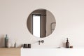 Round shower room mirror on beige wall with vanity Royalty Free Stock Photo