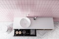 Round sink in pink tile bathroom, top view