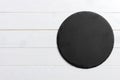 Round slate stand board a wooden background. space for text