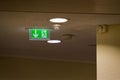 Ceiling smoke detector and emergency exit arrow for safety path Royalty Free Stock Photo