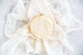 Round Soft Cow Cheese on Muslin Cloth and Blue Background