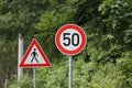 Round speed limit road sign on the road. 50 km per hour