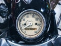 Round speedometer of an old Soviet black motorcycle. Closeup photo