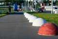 Round spheric concrete barriers of red and white color protect f