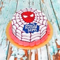 round spideman cake with white cream