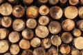 Round split logs piled in rows wood texture