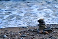 Round stacked stones on the shore Royalty Free Stock Photo