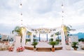 Round stage decorated with garlands stands between the laid tables