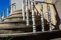 Round stairs with artistic railings bottom up view going upwards to the blue sky Royalty Free Stock Photo