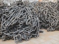 Round steel link chains for conveying and elevating equipment and systems folded in a heaps. Stacks of chains