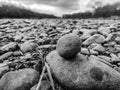 Round stone close-up. Nature. Against the background of a pile of river pebbles