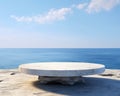 Round stone display table at ocean side is Futuristic.