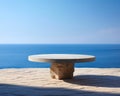 Round stone display table at ocean side is Futuristic.