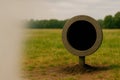 A round stone frame with a black void on a green field. Space for text. Royalty Free Stock Photo