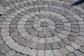 Round stone pavement pattern. Sidewalk tiles laid out from the center. Royalty Free Stock Photo