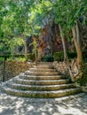 Round stone stairs in natural landscape with stone walls Royalty Free Stock Photo