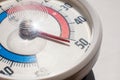 Round street outdoor thermometer with arrow shows extremely high temperature on hot sunny summer day. Close up view Royalty Free Stock Photo