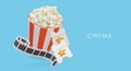Round striped cup filled with popcorn, film strip, tickets with gold stars