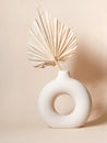 Round stylish ceramic vase with dried palm leaf