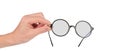 Round stylish glasses for vision in a male hand on a white background