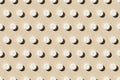 Round tablet pill pattern on a beige background. Hard shadows