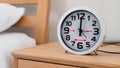 Round Tabletop Clock on Wooden Bedside Table â AI Generated Content Royalty Free Stock Photo