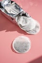 Round tea bag on pink background, sun shadows Royalty Free Stock Photo