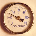 A round temperature meter on the returning water to a district heating system Royalty Free Stock Photo