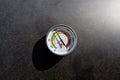 A round thermometer showing 100 degrees Celsius placed on a charcoal grill. Royalty Free Stock Photo