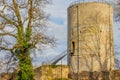 Round tower of Stein castle ruins on a hill, metal staircase, bare tree, climbing plant on the trunk Royalty Free Stock Photo