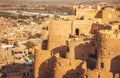 Round towers of historical Jaisalmer fort with monumental stone walls over the old city in Rajasthan, India