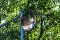 Round traffic, safety mirror at blind intersection of a hiking trail Royalty Free Stock Photo