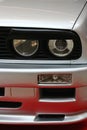 Round twin front headlights of first generation of high performance compact coupe BMW E30 M3