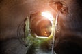 Round underground urban sewer tunnel with dirty sewage water