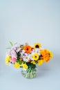 Round Vase with huge multicolor various mixed flower bouquet on the light gray, white background. Giving flowers Royalty Free Stock Photo