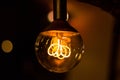 Round vintage lightbulb with glowing wire