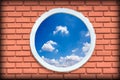 round and vintage window against blue sky on a brick wall building with vignette.round and vintage window against blue sky on a b Royalty Free Stock Photo