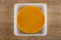 Round wafers in white box on wooden table. Top view Royalty Free Stock Photo