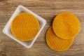 Round wafers in plastic box, wafers on wooden table. Top view Royalty Free Stock Photo
