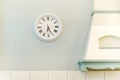 Round wall clock in kitchen interior. clock next to kitchen hood. Interior details, Provence style Royalty Free Stock Photo