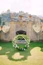 Wedding at an old winery villa in Tuscany, Italy. Round wedding arch decorated with white flowers and greenery in front Royalty Free Stock Photo