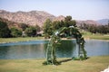 Round wedding arch with eucalyptus leaves, blue hydrangea flowers with waterfall and mountains. Outdoor wedding ceremony Royalty Free Stock Photo