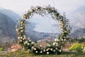 Round wedding arch stands on a mountain on the Bay of Kotor in the valley