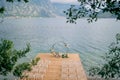 Round wedding arch stands on a wooden pier in front of rows of white chairs Royalty Free Stock Photo