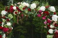 Round wedding floral arch from colorful fresh flowers outdoors before the wedding ceremony - wedding decoration