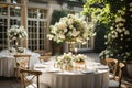 Round wedding guest table set for an exquisite dinner with beautiful flower arrangements