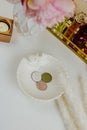 Round white, beige and green blush and eyeshadow on white plate Royalty Free Stock Photo