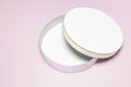 Round white cardboard blank box top view flat lay. Mock up on pink background. Packaging design, an empty box for shopping. Royalty Free Stock Photo